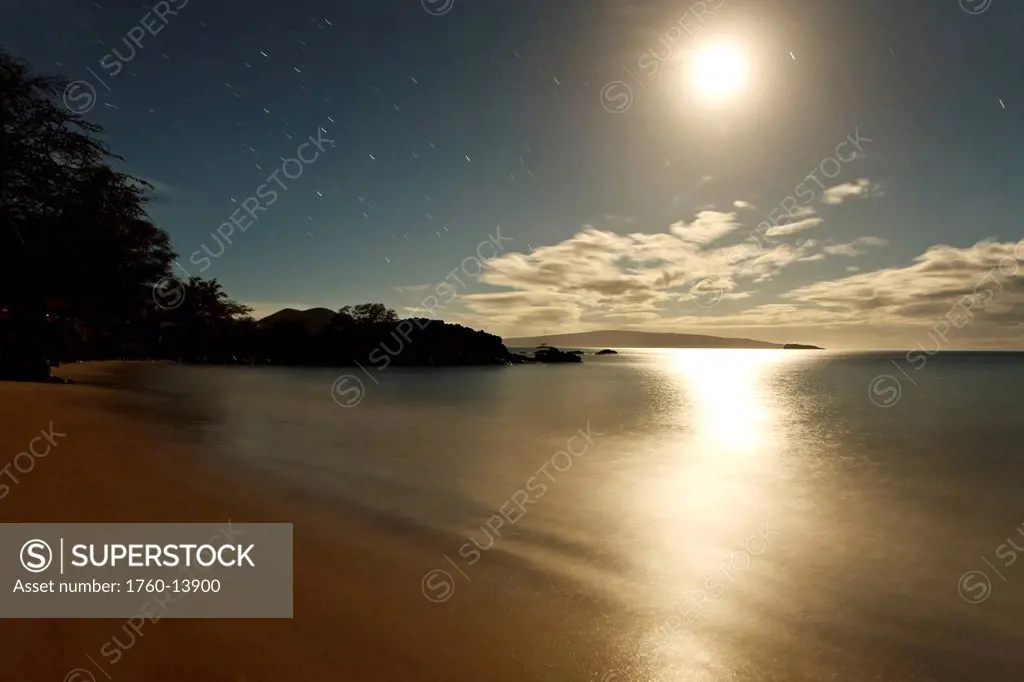 Hawaii, Maui, Makena, Moon shining over ocean at night, Kahoolawe in distance.