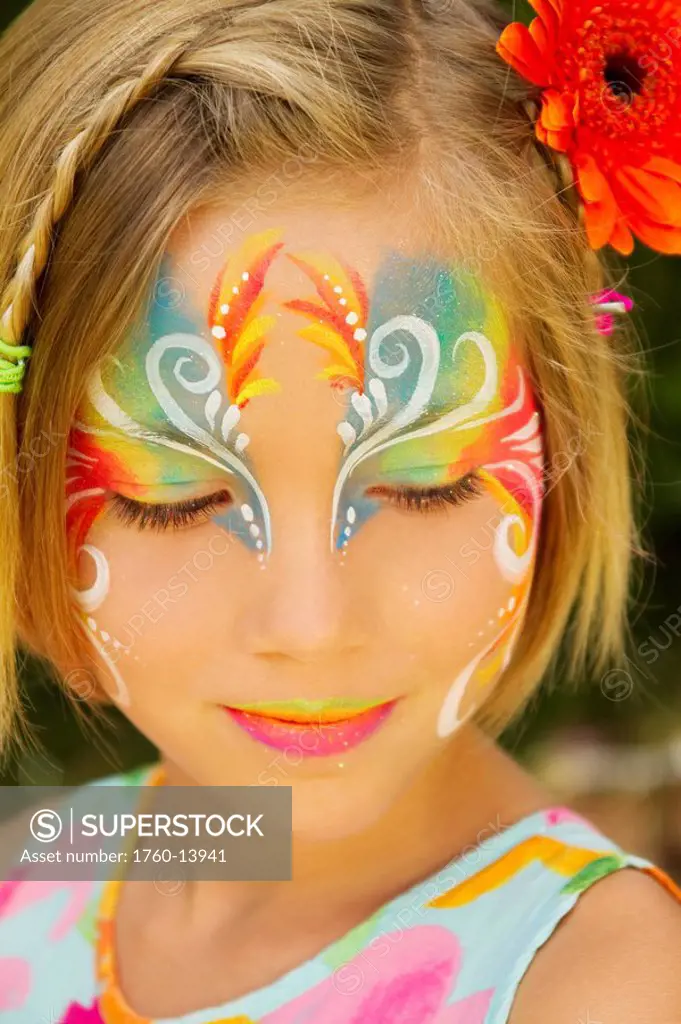 Hawaii, Young girl wearing colorful facepaint.