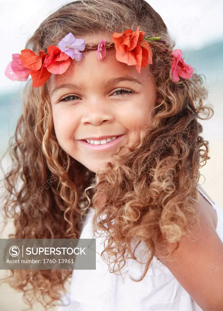 Hawaii, Oahu, Lanikai, Young girl wears flower headband at beach.