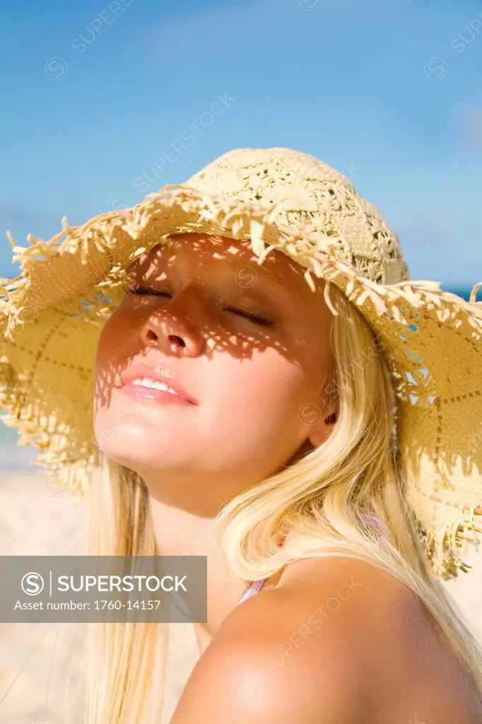 Hawaii, Blond woman enjoying a bright sunny day at the beach.