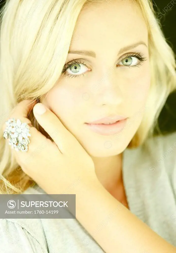 Hawaii, Kauai, North Shore, Blonde woman models for headshot wearing large diamond ring.
