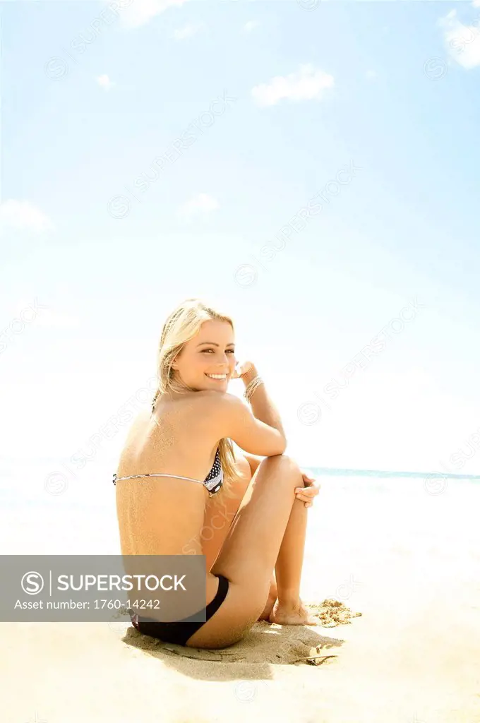 Hawaii, Kauai, Kealia, Beautiful blonde model poses on beach.