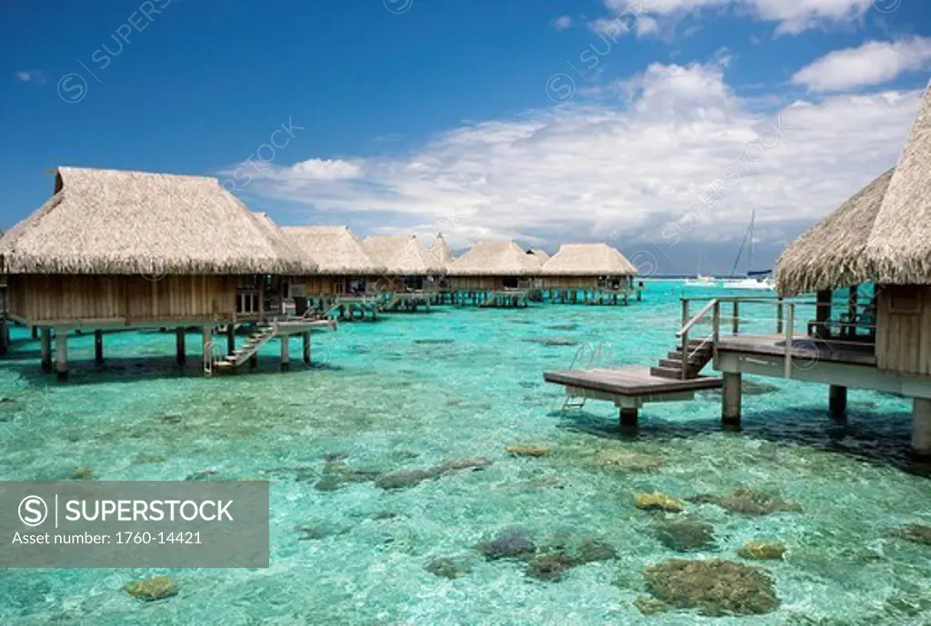 French Polynesia, Moorea, Luxury resort bungalows over ocean.