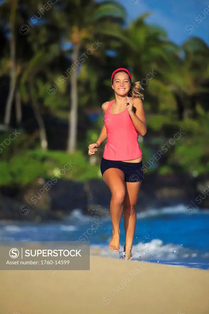 Hawaii, Oahu, Lanikai, Young woman running on beach.