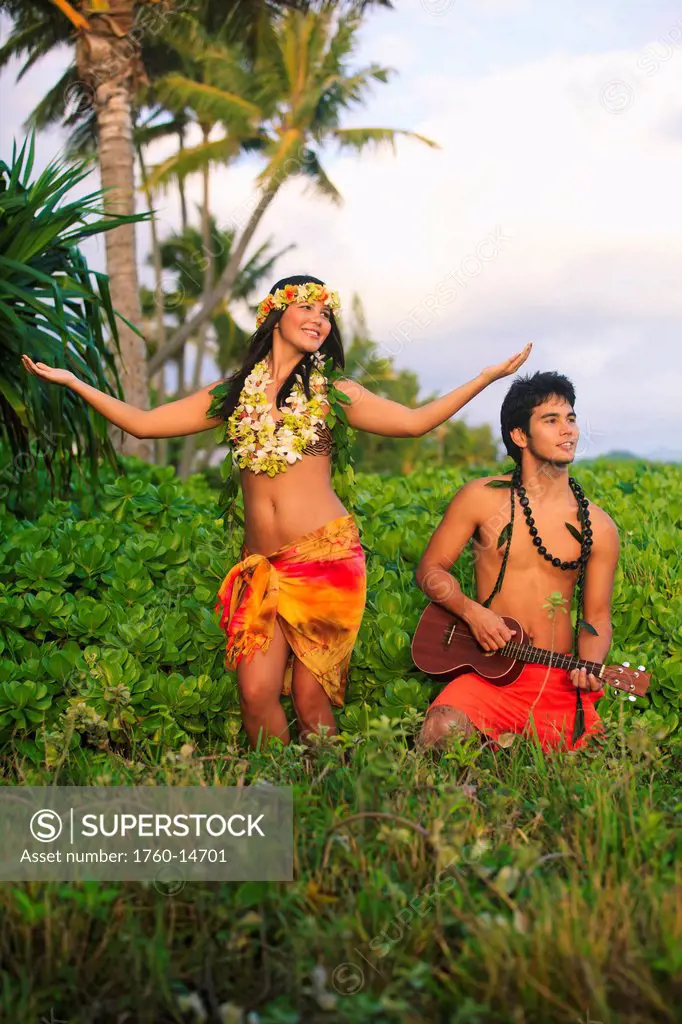 Hawaii, Oahu, Hula dancer couple in tropical setting.