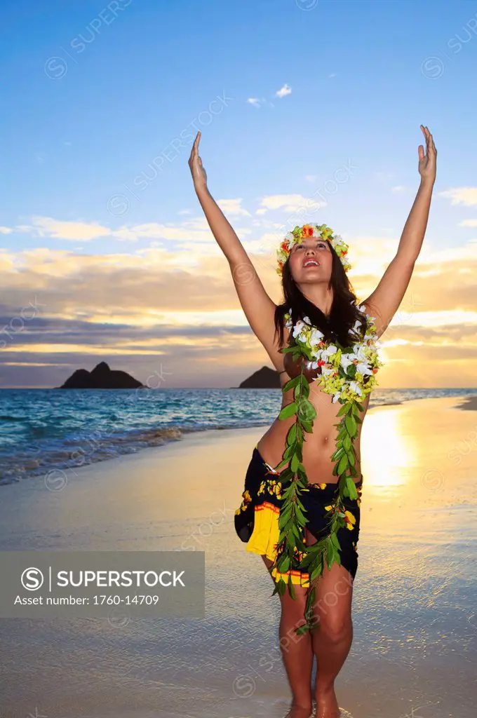 Hawaii, Oahu, Lanikai, Female hula dancer along beach shoreline at sunrise.