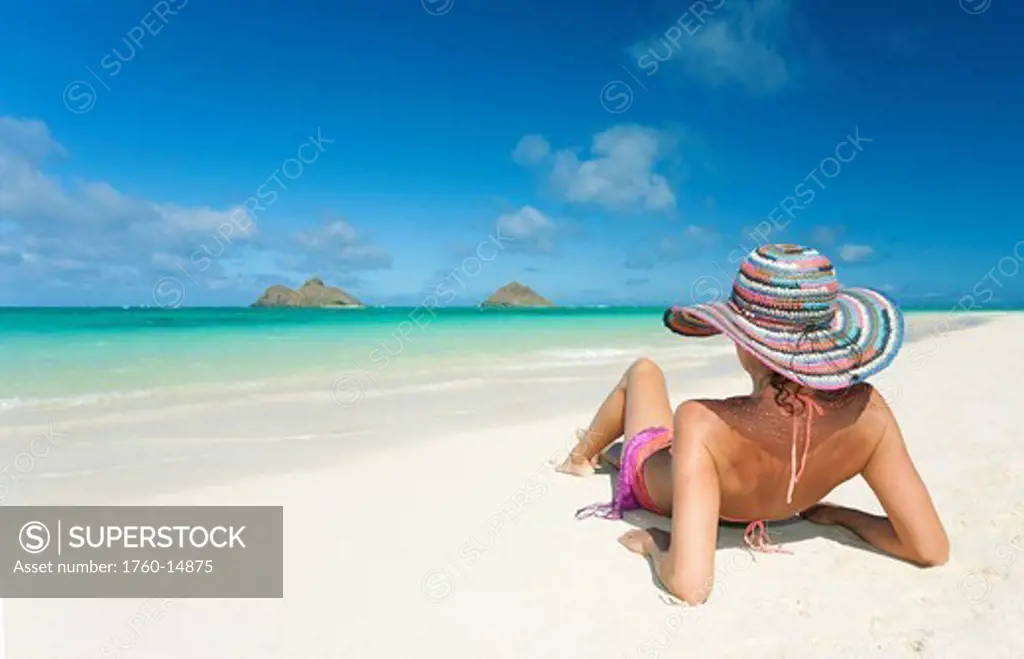 Hawaii, Oahu, Lanikai Beach, Woman relaxing along sandy shore.
