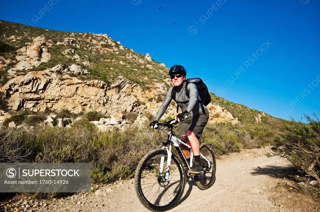 California, Morro Bay, Man biking on Quarry Trail.