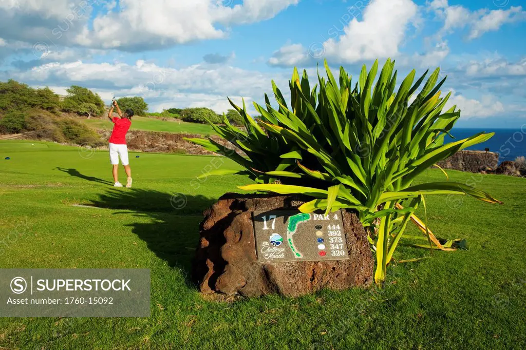 Hawaii, Lanai, Woman hitting a tee shot on The Challenge at Manele golf course.