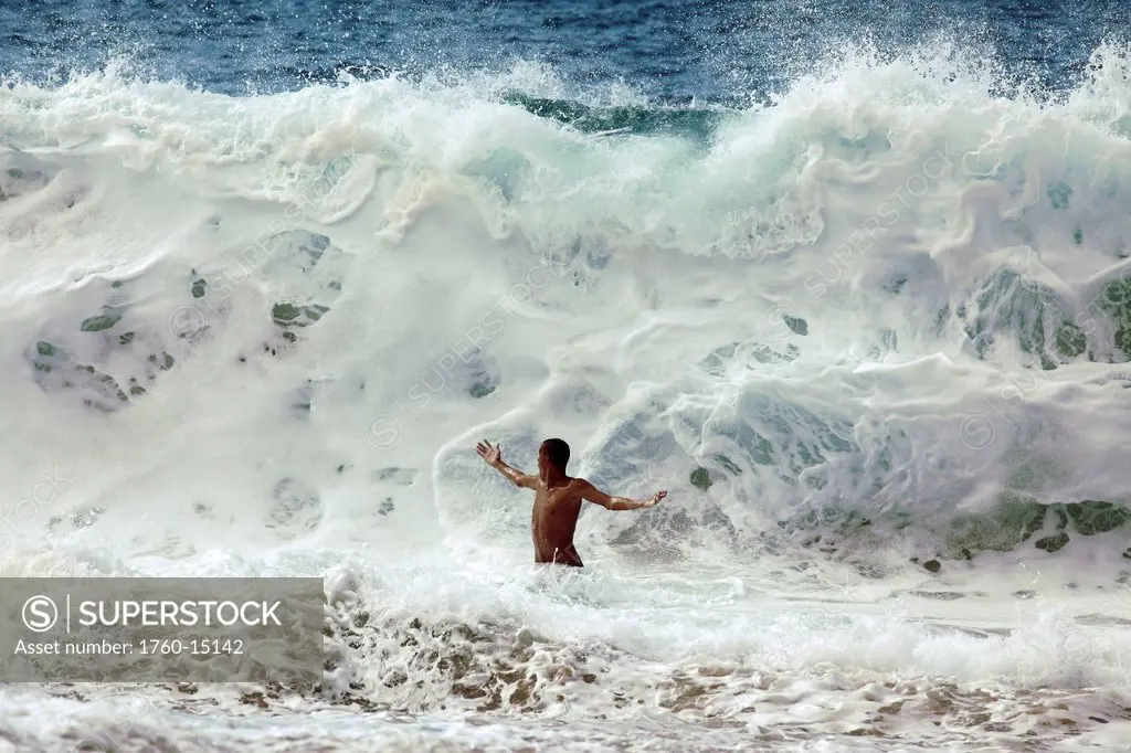 Hawaii, Oahu, North Shore, Man is about to be crushed by giant wave.