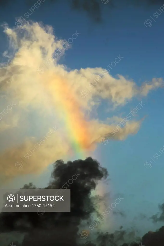 Hawaii, Oahu, Partial rainbow in cloudy sky.