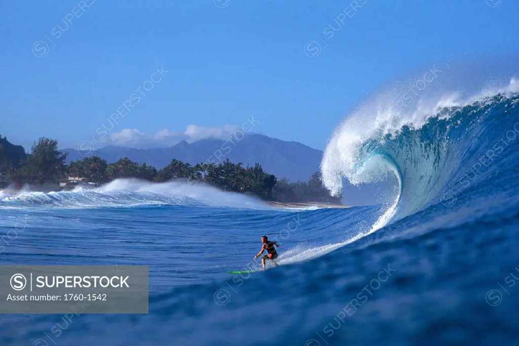 Hawaii, NorthShore Oahu, Noah surfs Pipeline, side view of breaking wave B1346