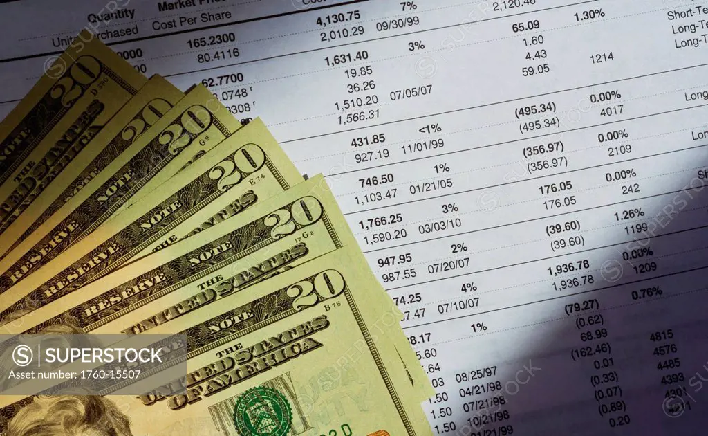 A stack of money lying on a stock investment portfolio