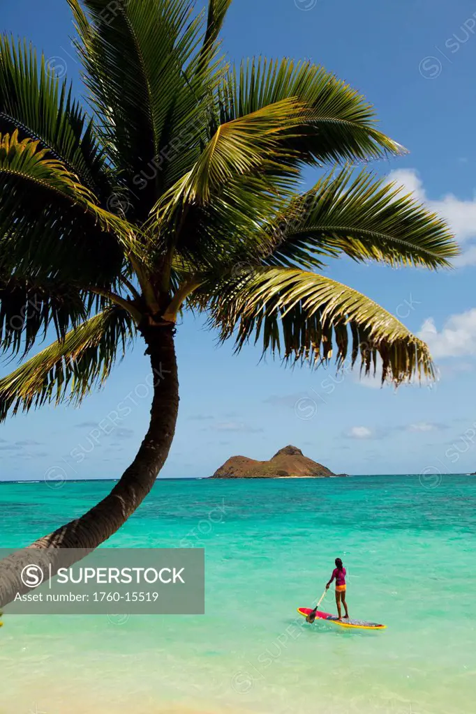 Hawaii, Oahu, Lanikai Beach,Female Stand Up Paddler on her way to the Mokulua Islands.