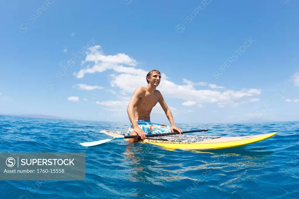 Hawaii, Maui, Athletic young man on a stand up paddle board