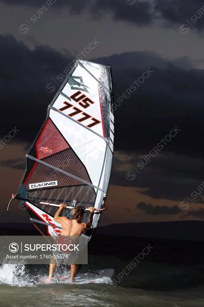 Hawaii, Maui, Kihei, Professional windsurfer Dean Christener sailing at sunset. FOR EDITORIAL USE ONLY.
