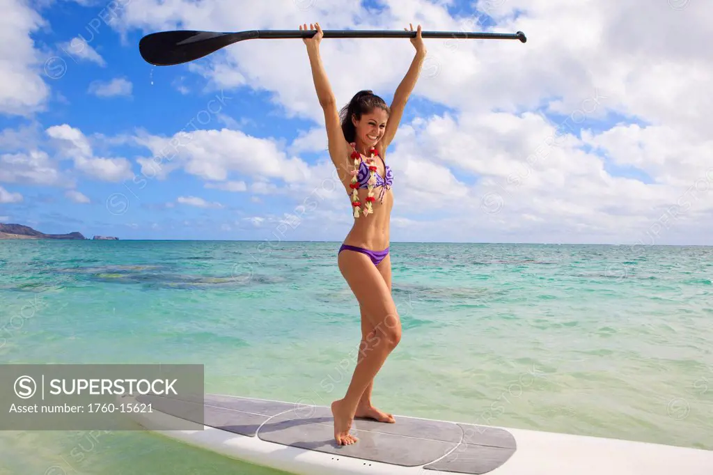 Hawaii, Beautiful brunette girl in bikini on her stand up paddle board