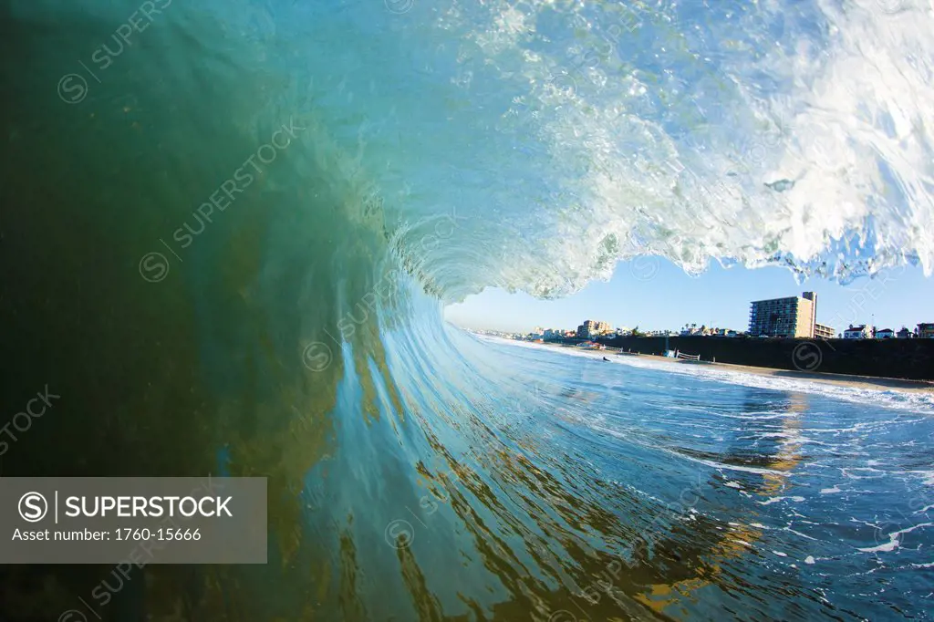 California, Ventura, Shore framed by a big breaking wave