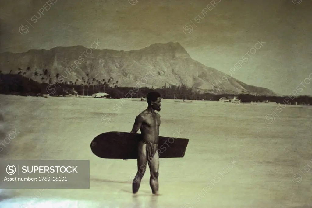 c.1890, Hawaii, Waikiki, Hawaiian on beach with surfboard, Diamond Head in background.
