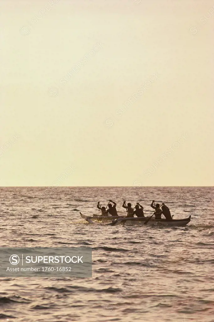 Hawaii, Big Island, Canoe Anaehoomalu Bay, paddlers silhouetted on ocean