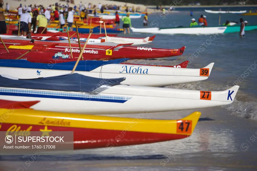 Hawaii, Oahu, Kailua, Lineup of colorful outrigger canoes on the shoreline at a canoe race