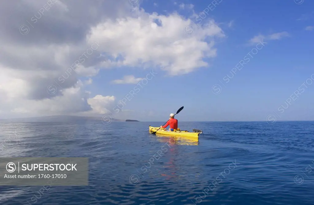 Hawaii, Maui, Man in yellow kayak along the calm ocean of the Southern coast.