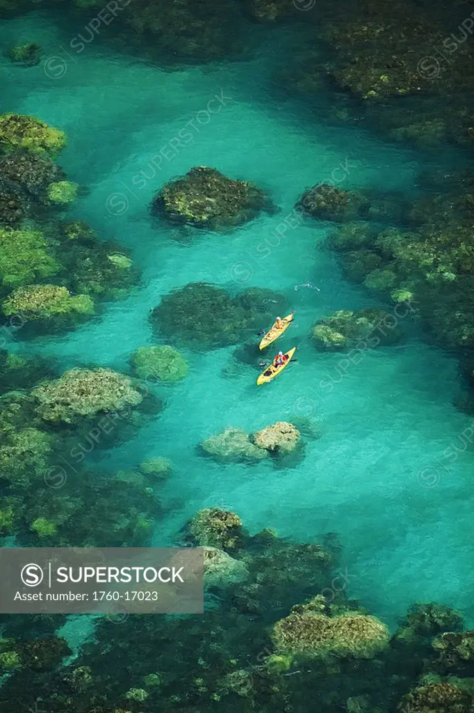 Hawaii, Maui, Two kayakers on ocean over beautiful coral formations off Olowalu, View from above