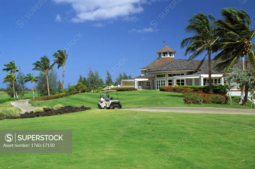 Hawaii, Big Island, Waikoloa King´s Course Clubhouse background senior couple on cart along path