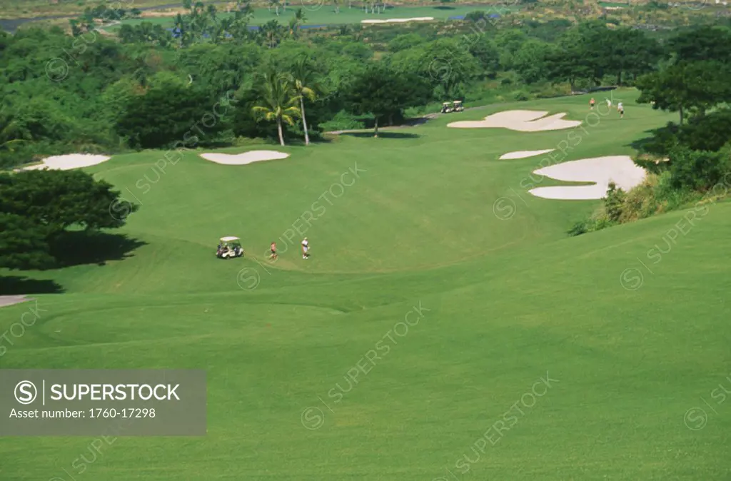 Hawaii, Big Island, South Kona, Hokulea Golf Course, Golfers on the green.