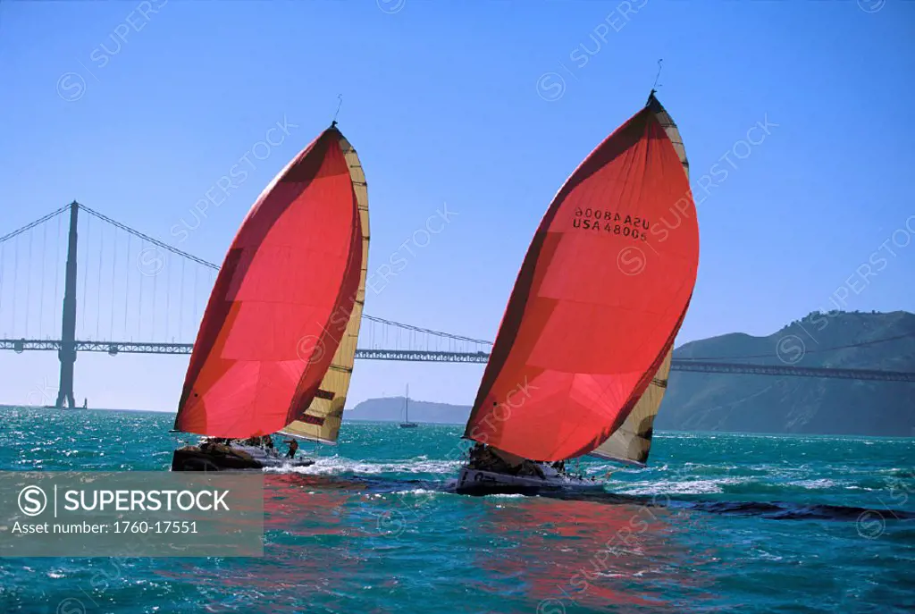 SF, Big Boat Series, Two yachts w/ red & yellow sails neck & neck across bay