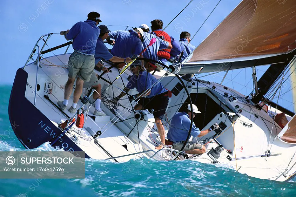 FL, Key West Race Week, c/u stern view of yacht leaning into water, crew, MRA waiver