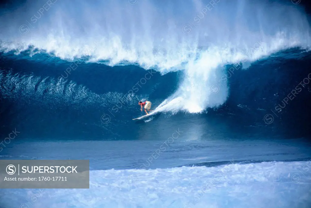 Hawaii, Pipe Masters Contest Kelly Slater rides big wave, distant view