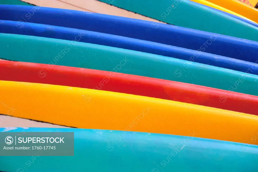Detail of many different colored surfboards, straight up