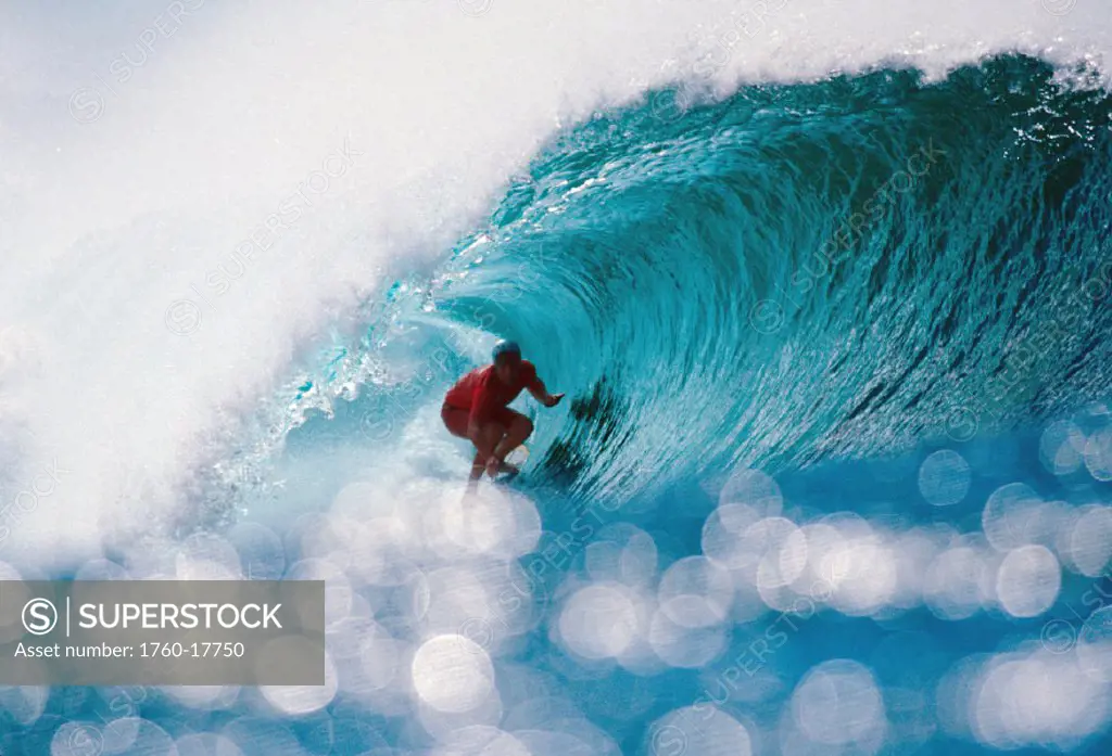 Hawaii, Oahu, North Shore, Pipeline, Shimmering water in foreground of Liam in wave curl