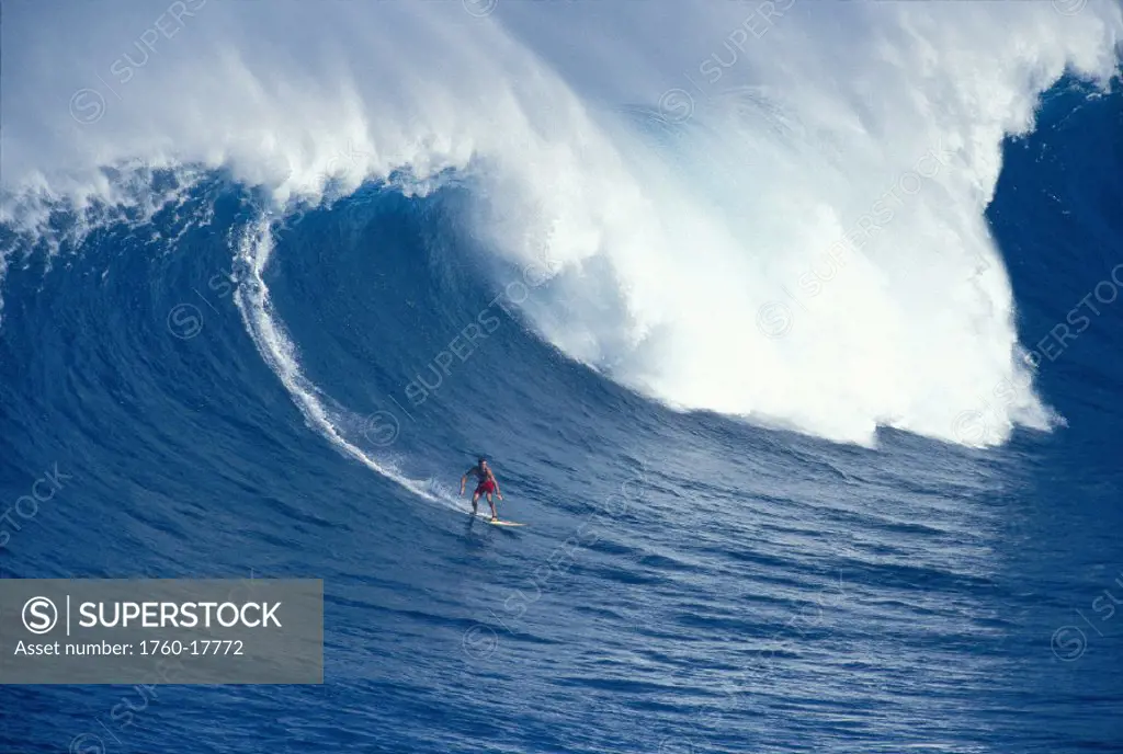 Hawaii Maui Jaws Sierra Emory rides huge wave, distant view D1227