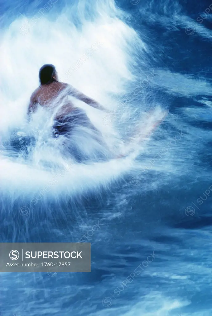 Surfer carving on splashing wave, interesting perspective and blur