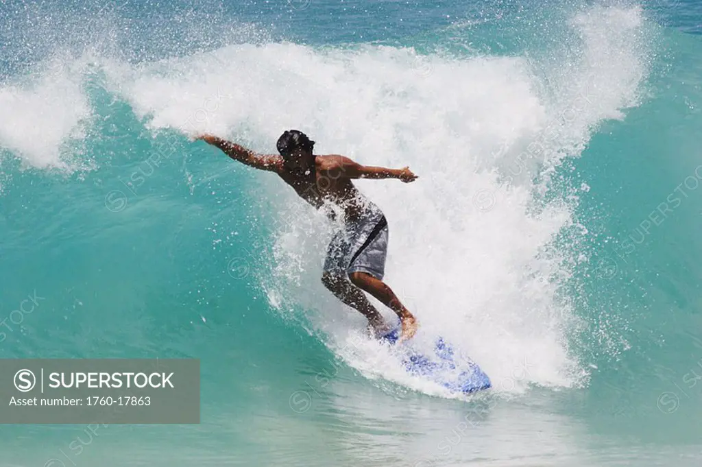 Hawaii, Oahu, Sandy Beach, surfer rides a wave