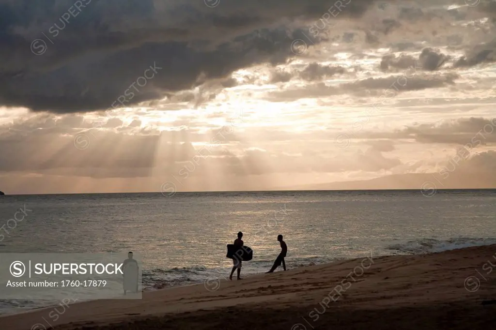 Hawaii, Maui, Makena Beach, Sunsets with boogie boarders on the beach.