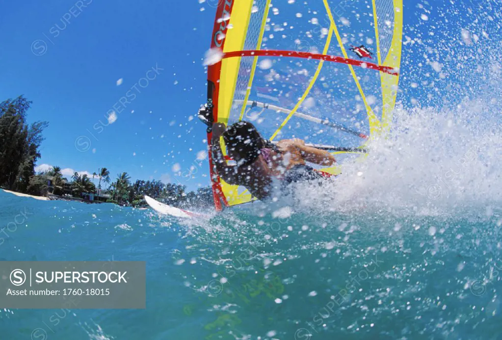 Hawaii, Maui, Kanaha, action view woman windsurfing, view from behind with spray