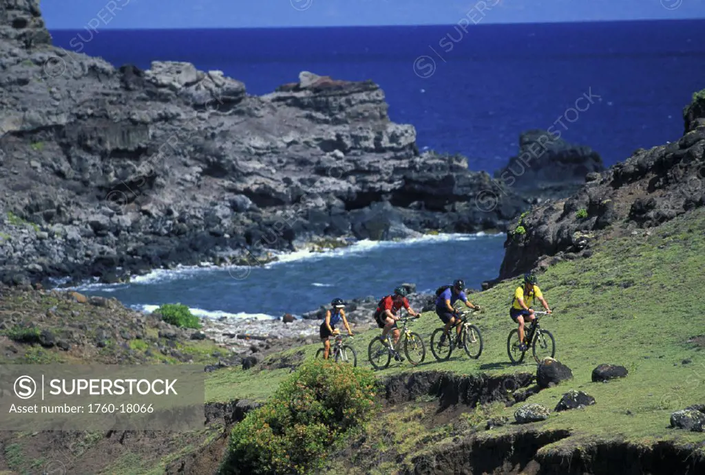 Hawaii, Maui, Mountain bikers biking uphill along the coast