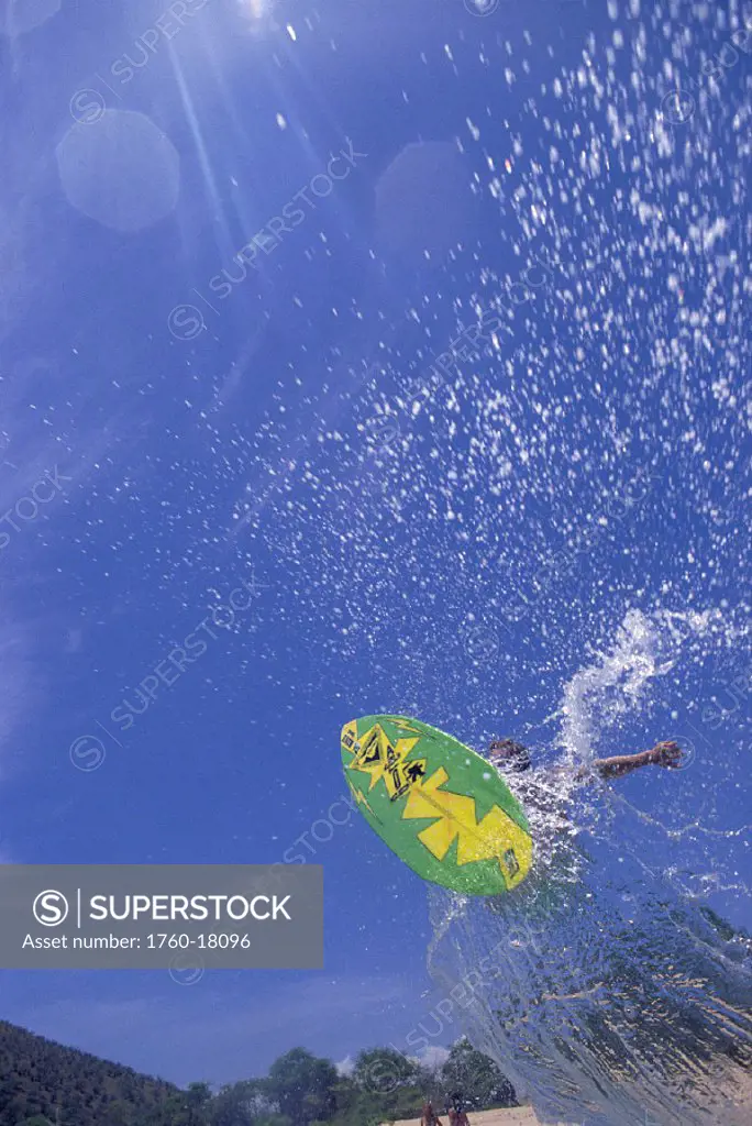 Hawaii Maui Makena upward vu person on skimboard vertical to ocean D1250 splash blue sky Big Beach