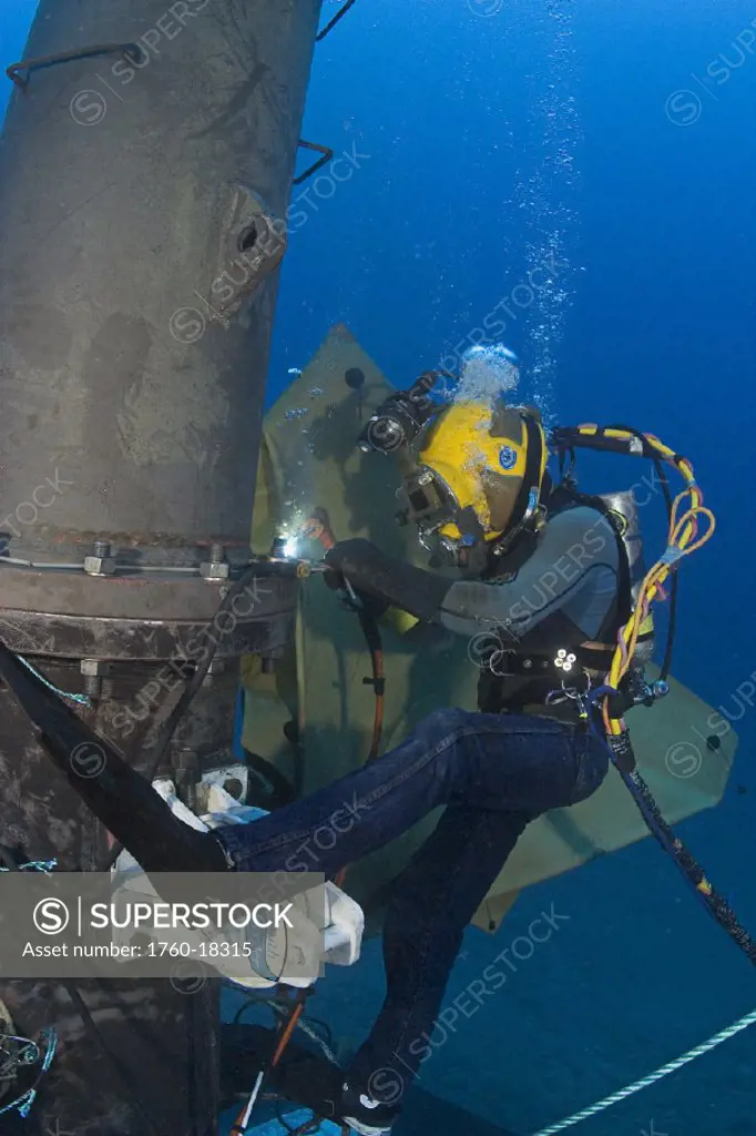 Hawaii, Oahu, A commercial hard hat diver underwater.