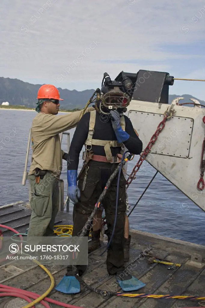 Hawaii, Oahu, A commercial hard hat diver prepares for a dive.