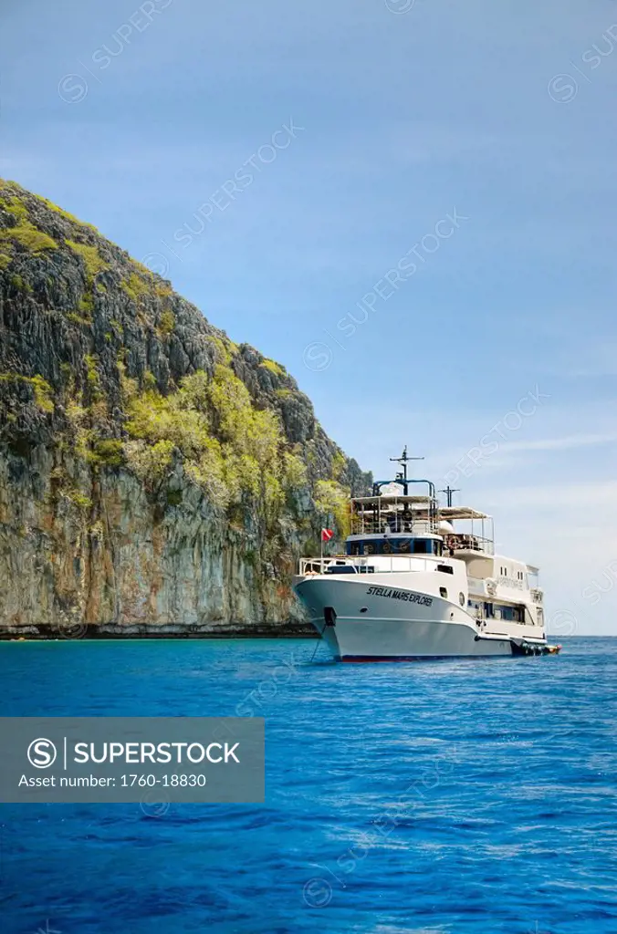 Philippines, Cuyo Archipelago, Quiminatin Island, Dive boat cruising in blue ocean water.
