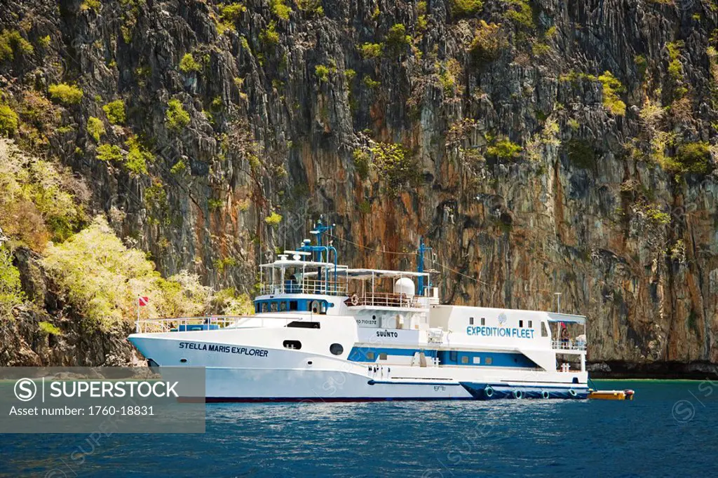 Philippines, Cuyo Archipelago, Quiminatin Island, Dive boat cruising in blue ocean water.