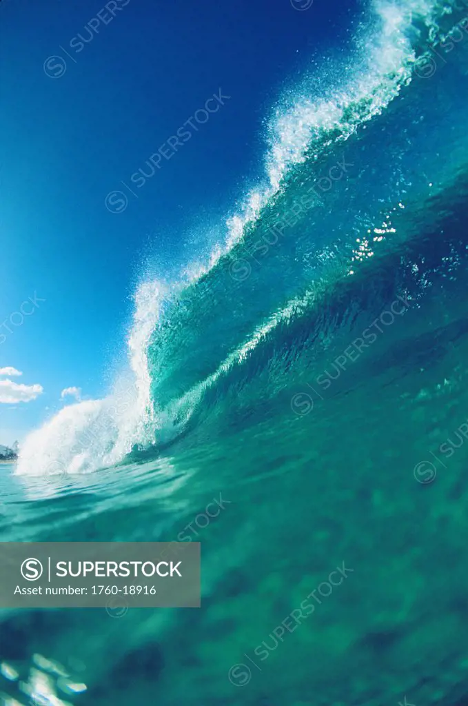 Close-up angle of wave breaking, clear turquoise