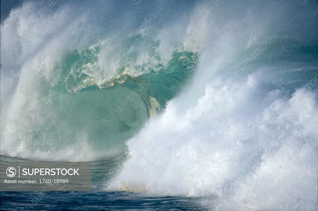 Side view of large turbulent waves crashing, whitewash and ocean spray