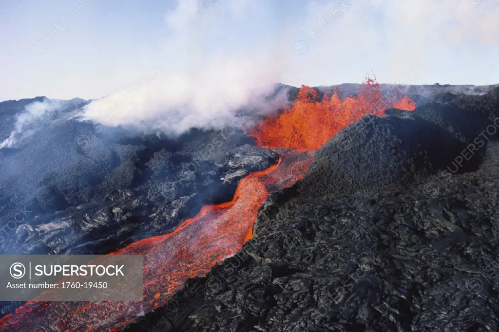 Hawaii, Big Island, Hawaii Volcanoes National Park, Mauna Loa eruption, lava flowing, steam rising.