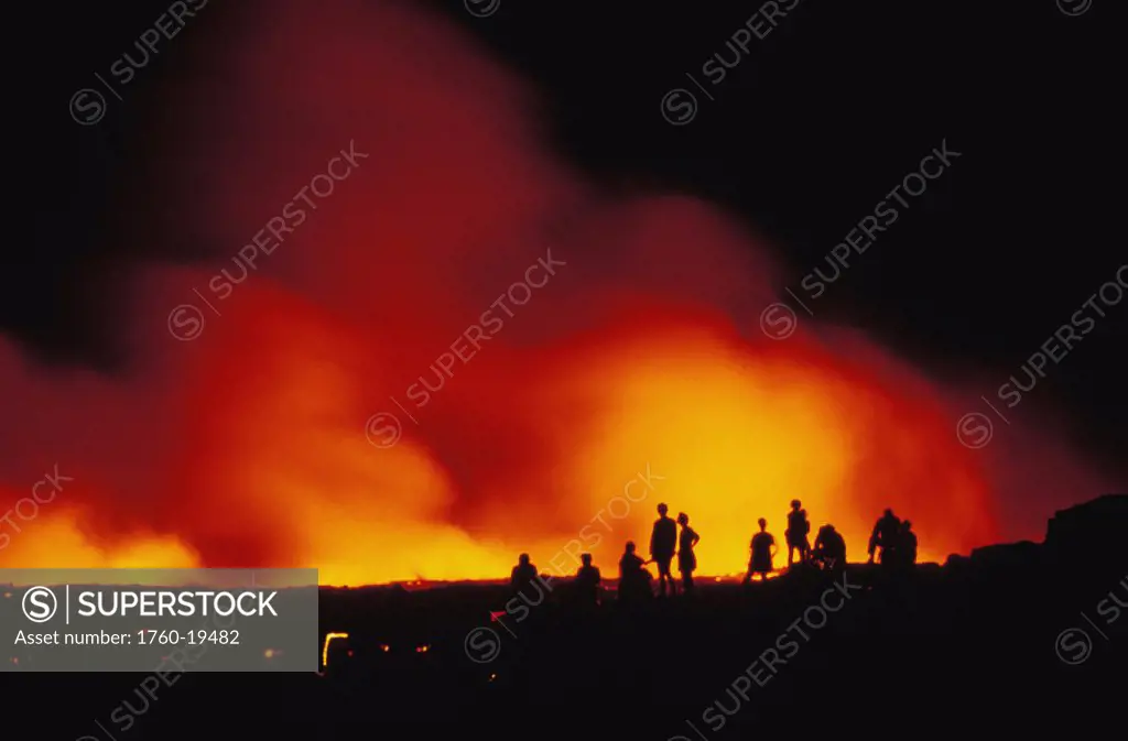 Hawaii, Big Island, Hawaii Volcanoes National Park, tourists watch lava flow into ocean, nighttime glow
