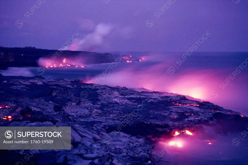 BigIsle, Hawaii Volcanoes NP Lava flows into ocean, pink hues along coastline